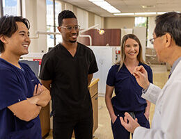 professor speaking to dental students on clinic